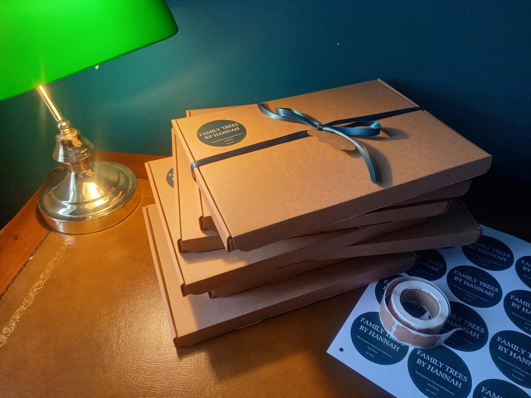 Gift boxes sealed with Family Trees by Hannah stickers, ready to post
