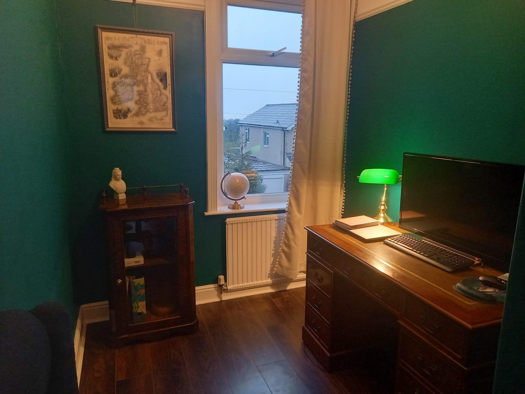Hannah's study, with its teal wall and green banker's lamp